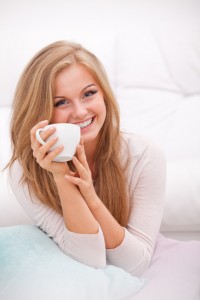 woman holding white cup